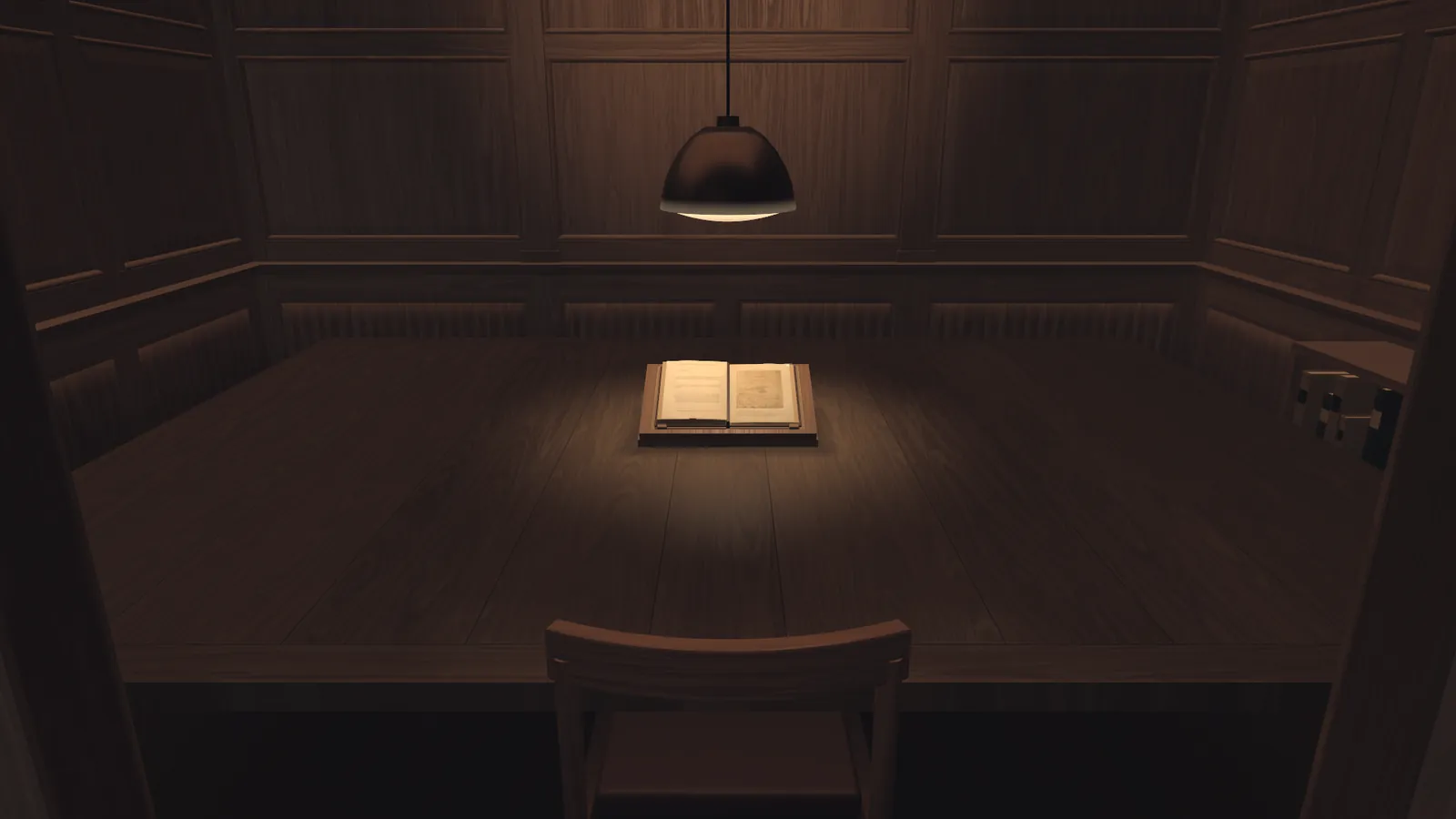 A dark panelled room with one hanging lamp. Under the lamp an open book lies on a long table, and a chair stands in front of it. A still from the museum's film.